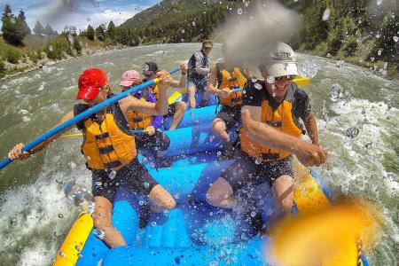 a group paddles through rapids while whitewater rafting in Jackson Hole, WY