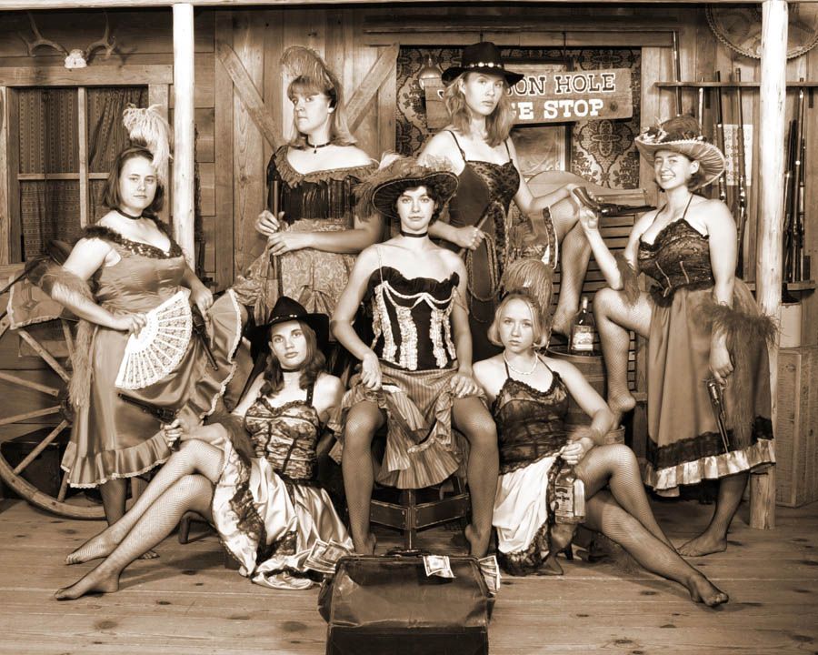 a group of women pose in western clothes for a photo at Old Time Photos in Jackson Hole