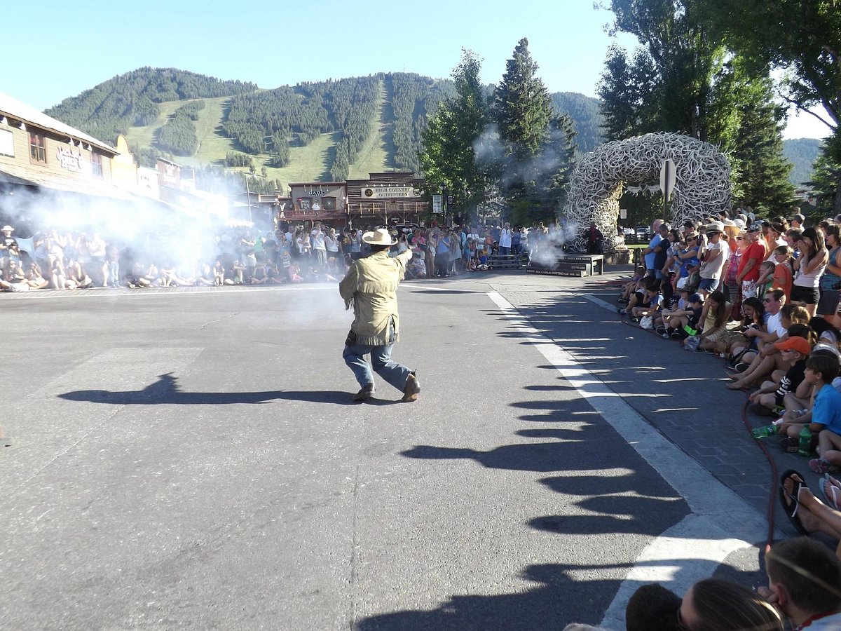 families watch as an actor shoots guns during the Jackson Hole Shoot Out