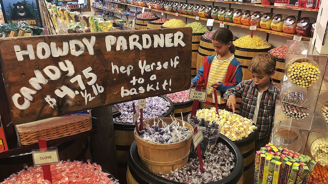 kids pick out candy from barrels of candy at a candy store in Jackson Hole