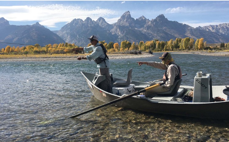 two men on a boat, fly fishing in Jackson Hole, WY