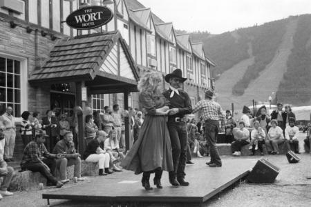 Black and white photos of a man and woman dancing on a stage in front of The Wort Hotel in Jackson Hole, WY 